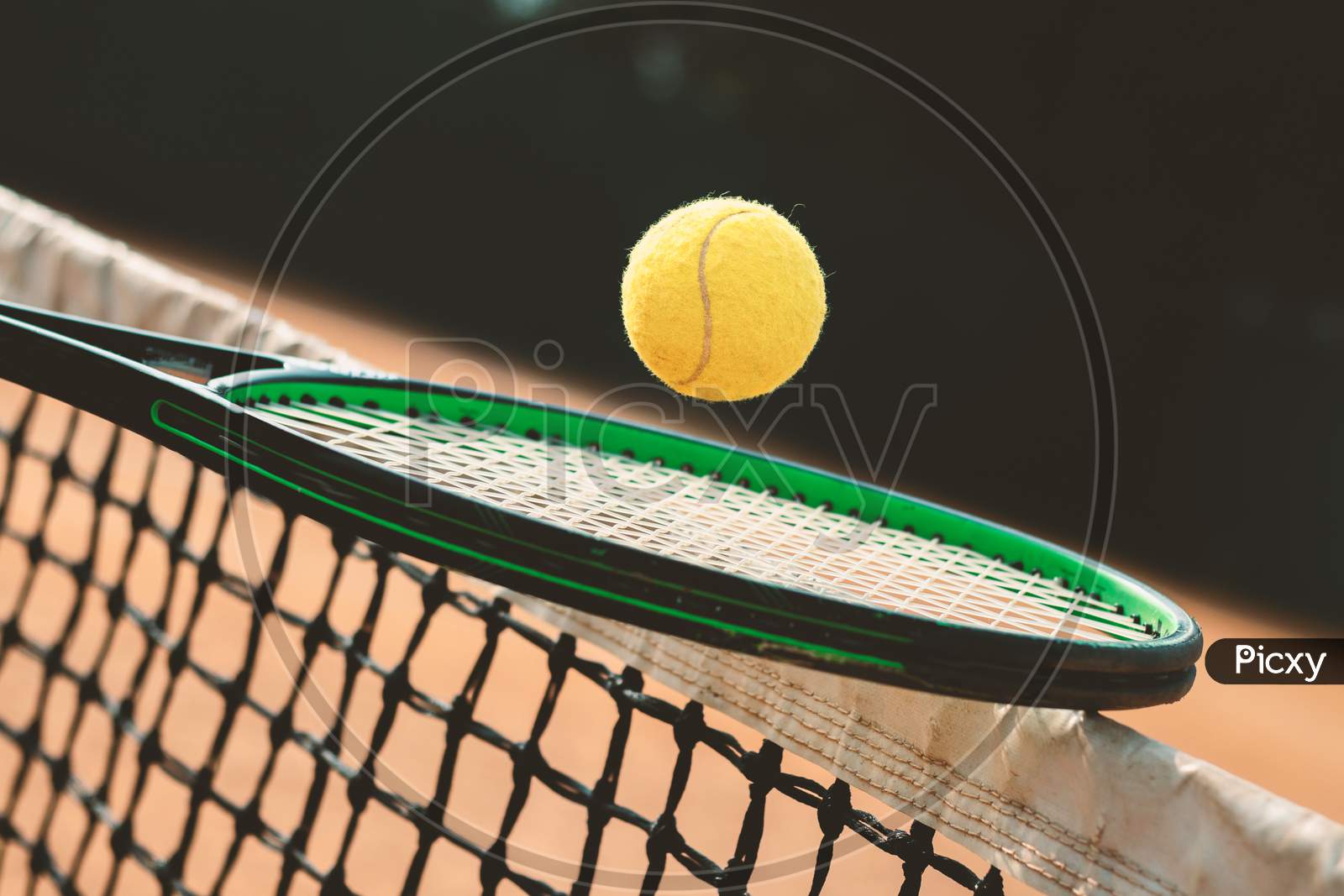 Tennis Racket And A Ball In A Court