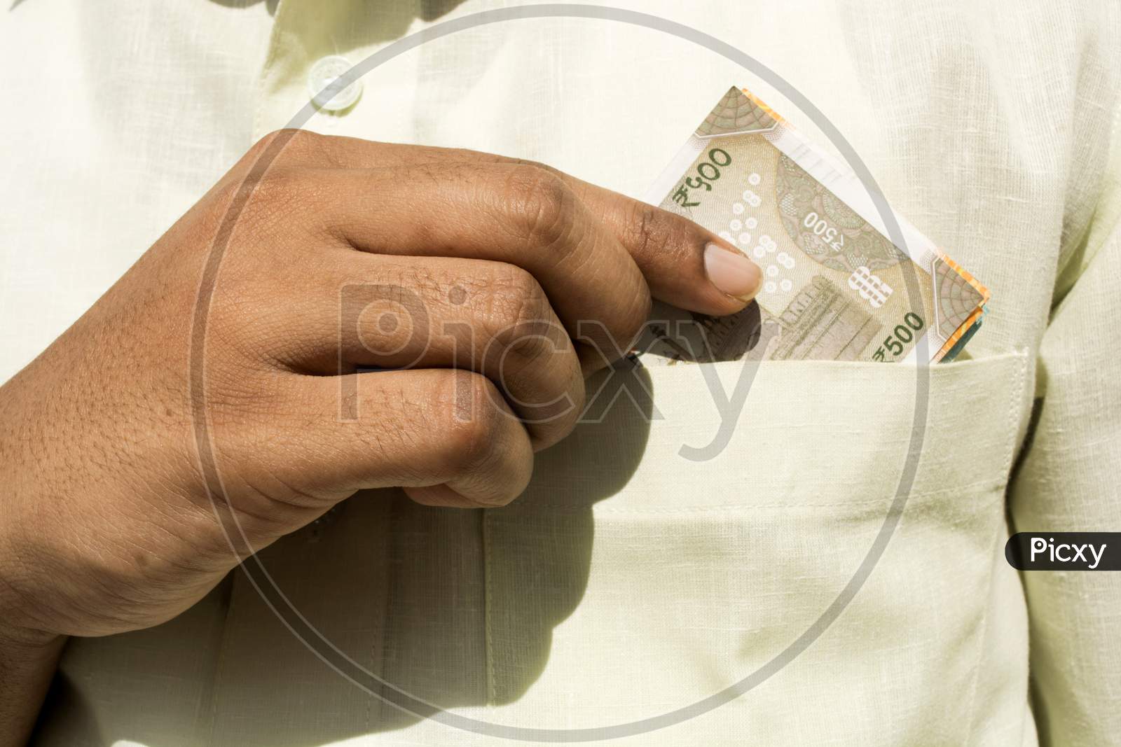Man Hand Takes A New 500 Indian Currency Note Out Of His Pocket Close Up