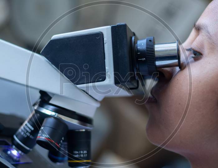 Close up shot of a Pharma Student Using Microscope In A Laboratory