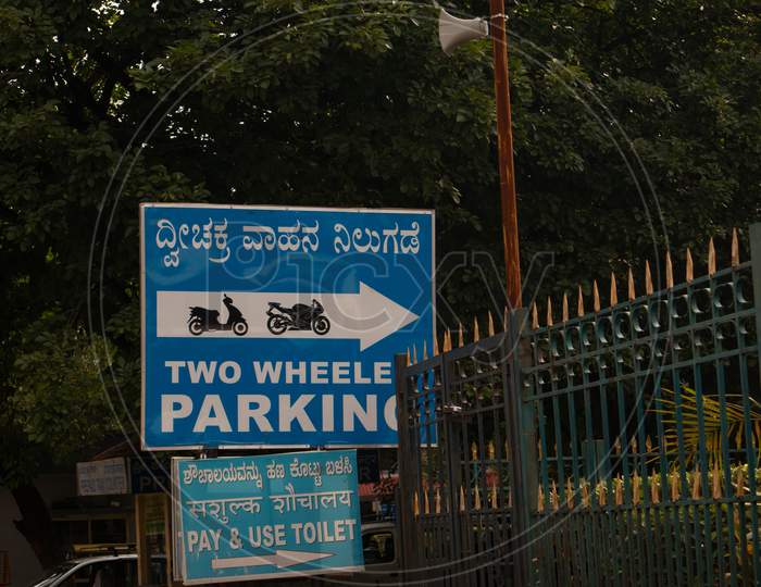 Two Wheeler Parking Sign Board on a Road Side