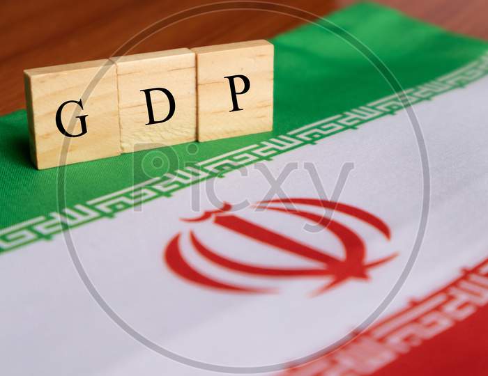 Gross Domestic Product Or Gdp Of Iran In Wooden Block Letters On Iran Flag.