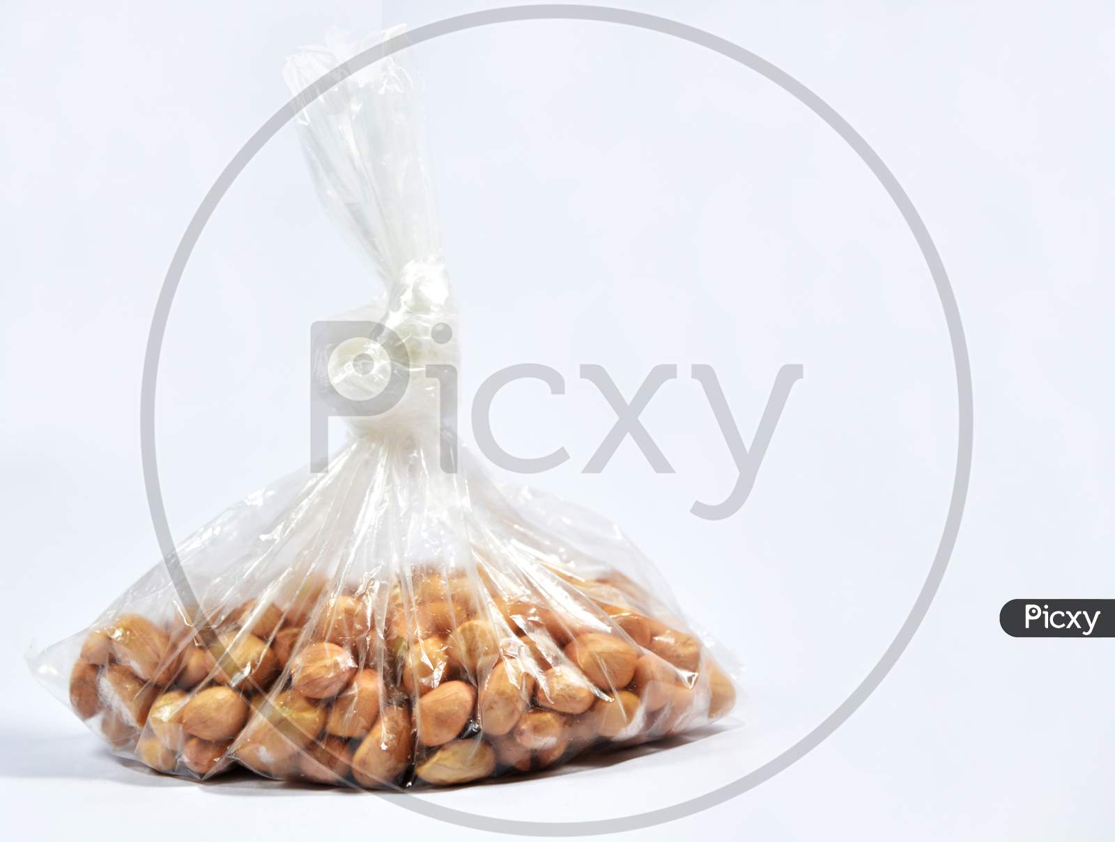 Raw Arachis Hypogaea,Peanut Or Groundnuts In A Bag On Isolated White Background.