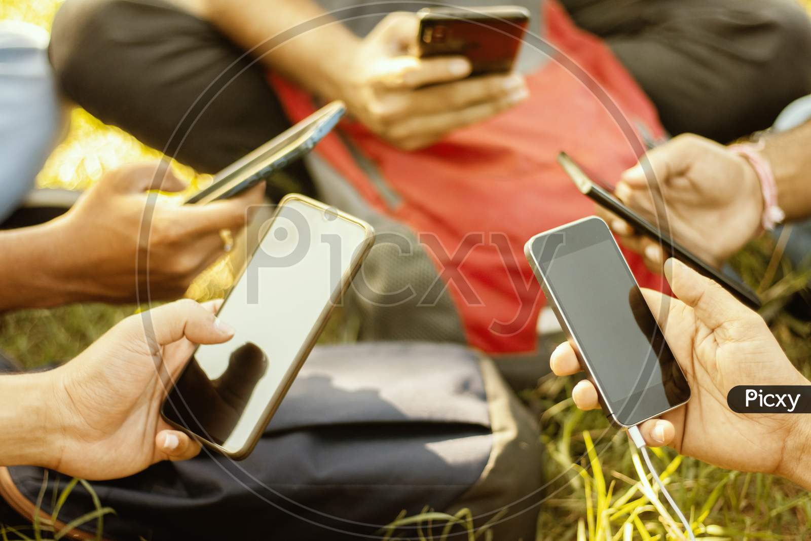 Selective Focus On Hands, Close Up Of Young People Hands Holding Mobile - College Students Addicted To Smartphone - Young Millennials Busy On Cell Phone - Group Of Friends Sharing Content On Social Media.