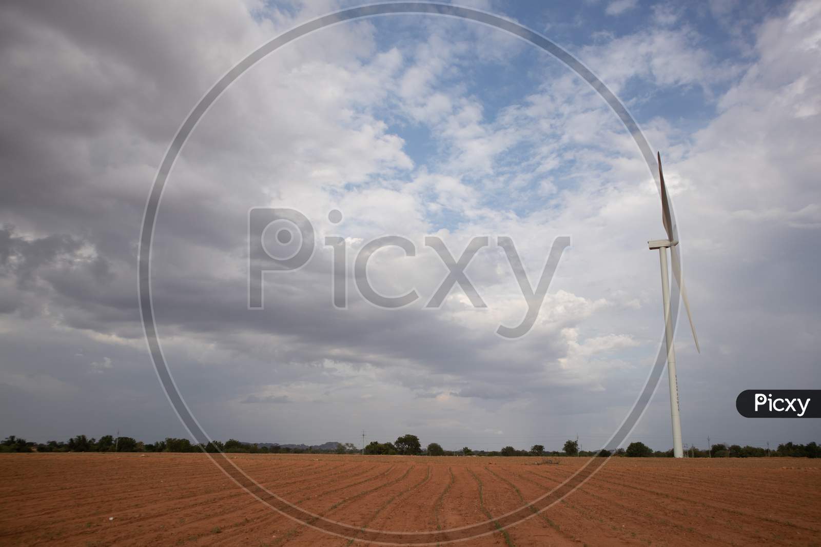 The landscape of an Agriculture Fields with A Windmill