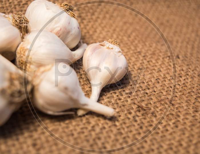 Group Of Garlic On Sackcloth For Food.