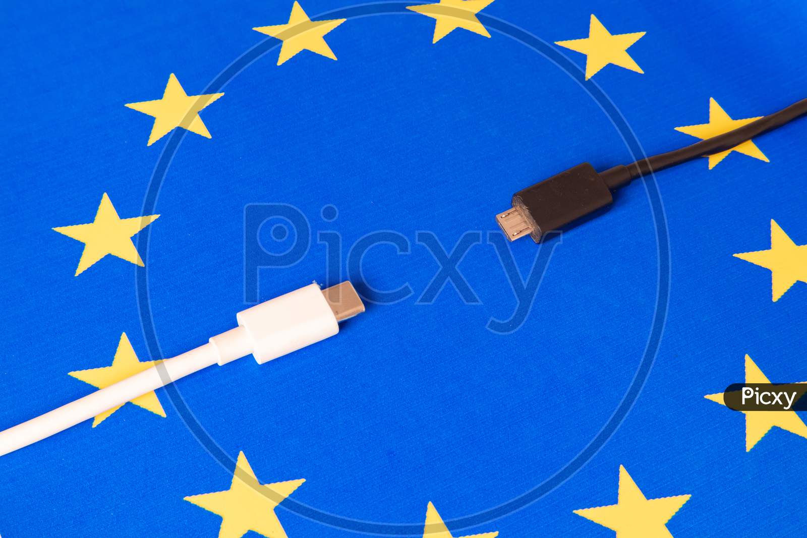 Close Up Mobile Phone Charger USB and Type - C Cord On Eu Flag