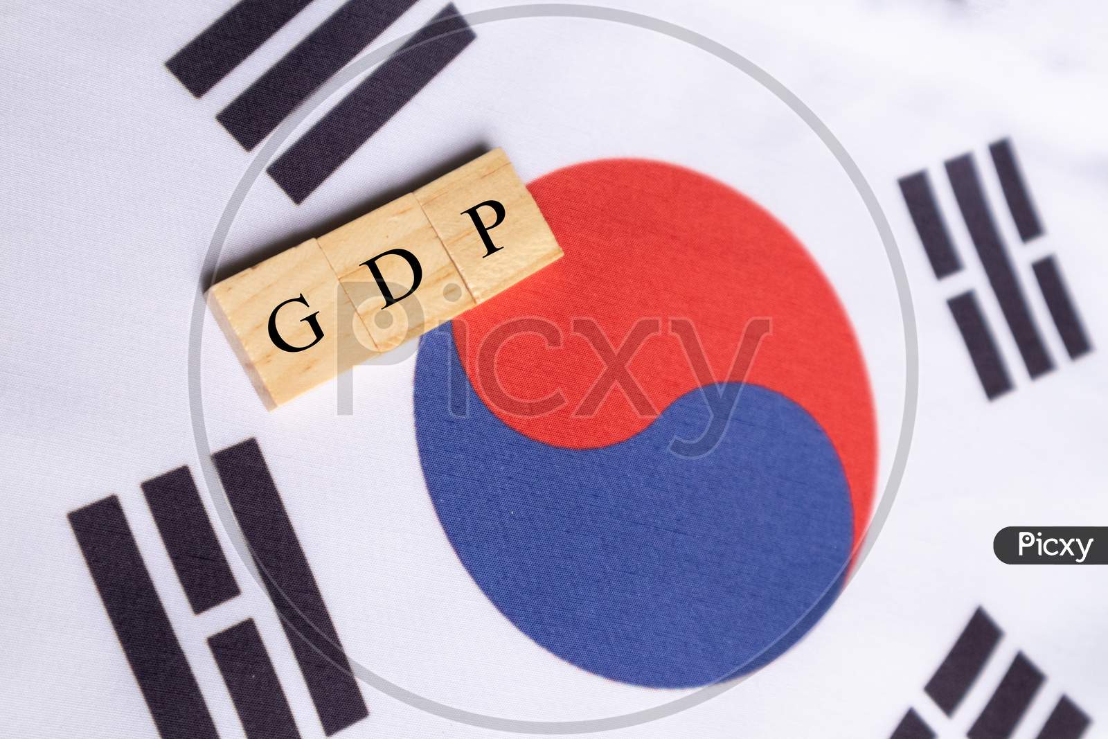 Gross Domestic Product Or Gdp Of South Korea In Wooden Block Letters On South Korean Flag.