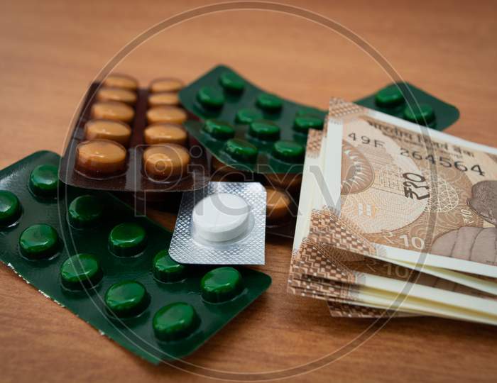Concept Of The Affordable Medicine In India Due To Generic Drugs On Indian Currency Notes As Background.