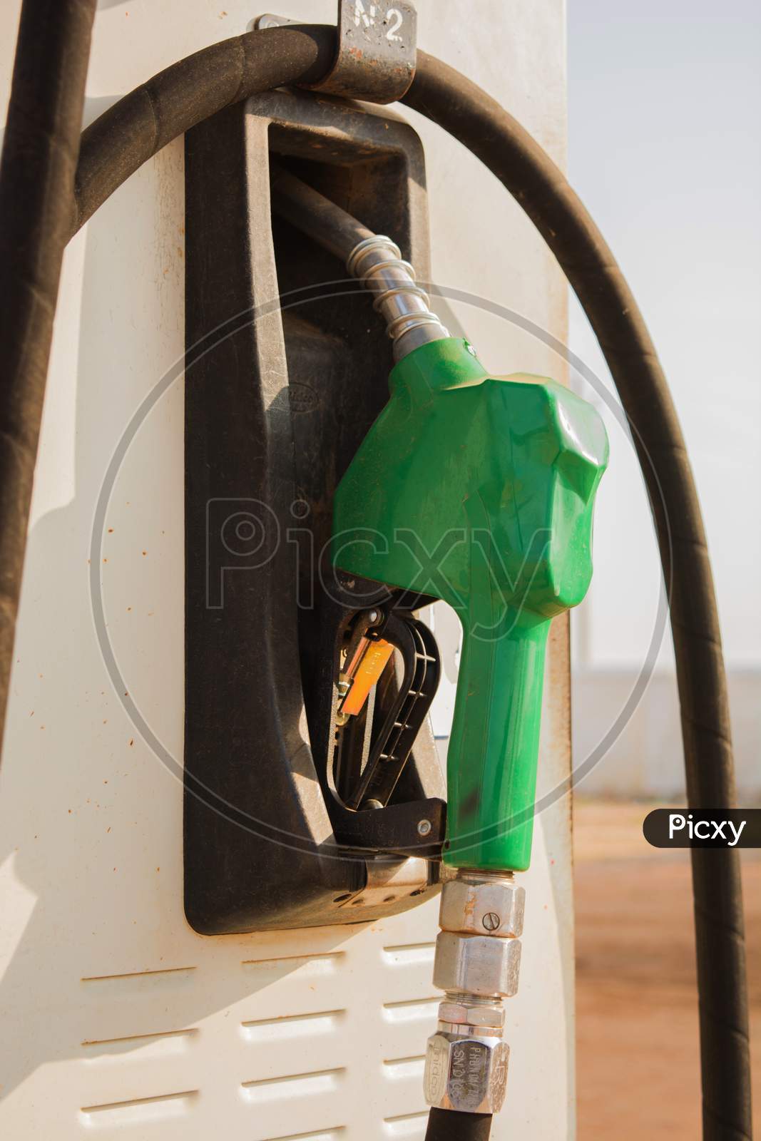 Fuel Oil Gasoline Dispenser At Petrol Filling Station.Holding Fuel Nozzle To Refuel Gasoline For Car.
