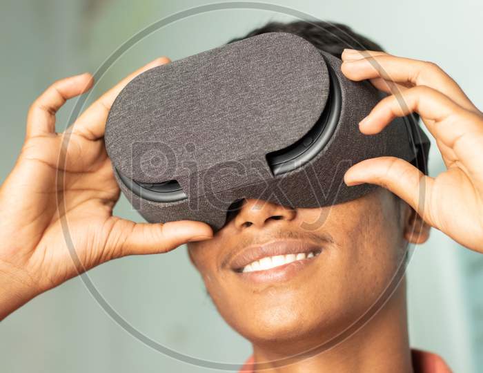 Closeup Of A Young Man Experiencing Virtual Reality Through A Vr Headset.