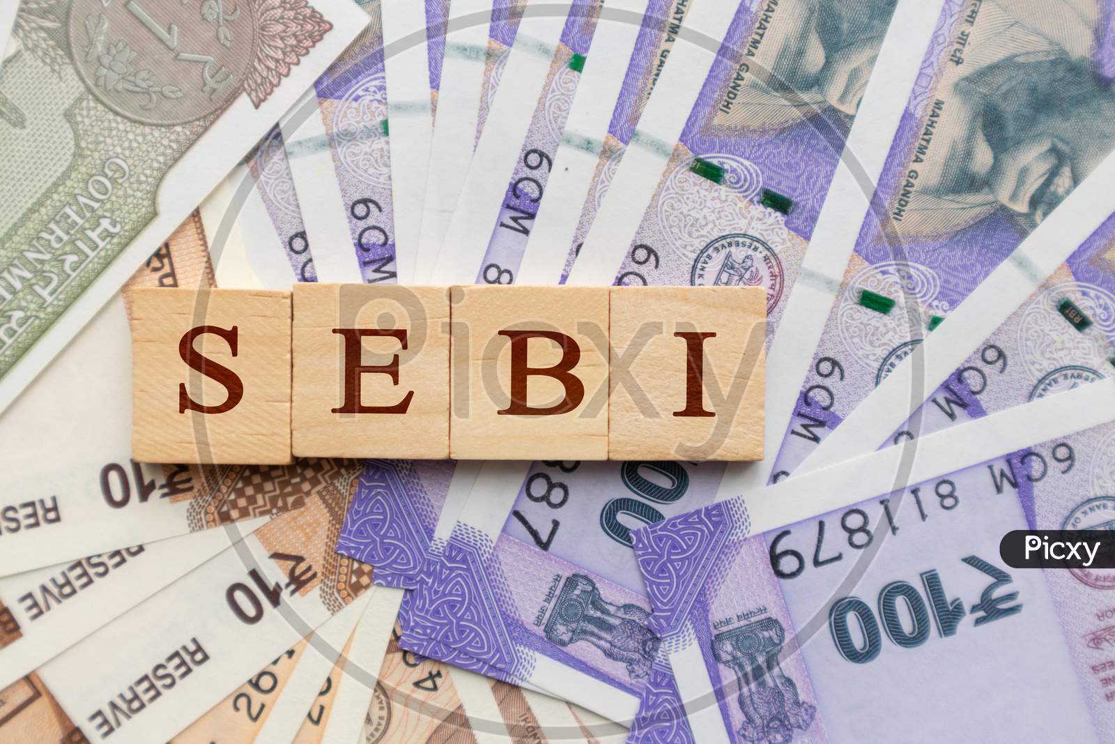 Sebi In Wooden Block Letters On Indian Currency.