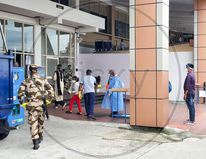 6Th June 2020- Bagdogra Airport,Siliguri, West Bengal, India-Passengers In Protective Gear Being Sanitized On Arrival By Airport Staff At Bagdogra Airport