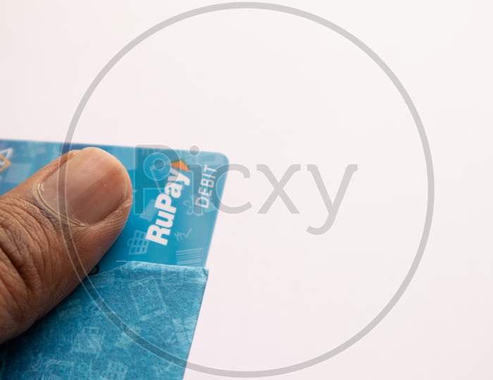 Closeup Of Hands Holding The Rupay Debit Cards On Isolated Background.