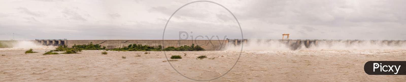 Panoramic Image Of Water Filled In Dam Due To Heavy Rain And The Gates Of The Reservior Is Opened To Release The Wtarer From The Reservoir Or Dam.