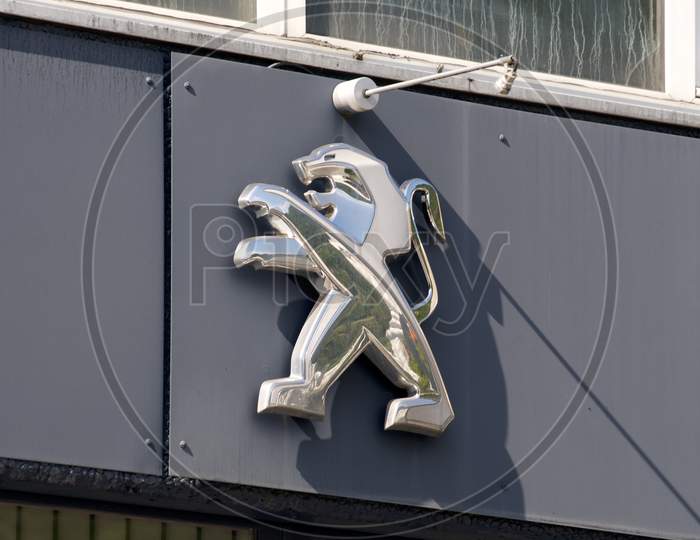 Peugeot Logo Hanging On Garage Exterior
