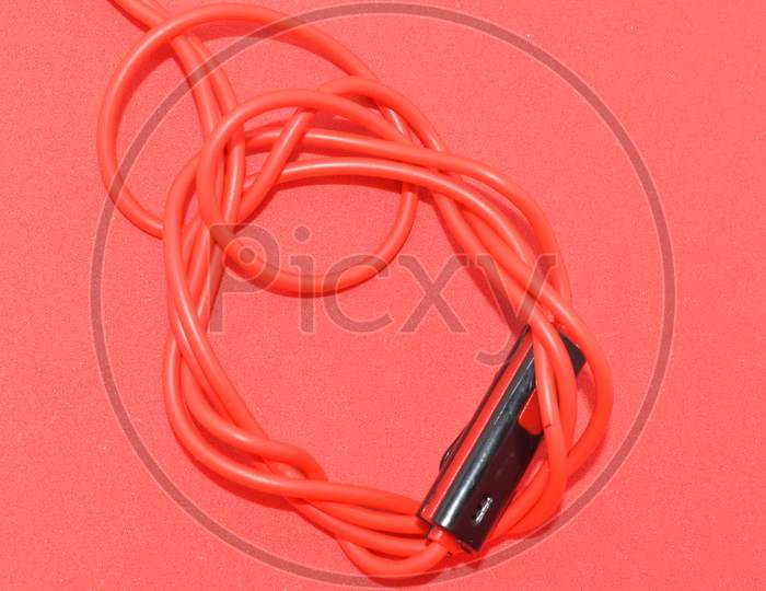 High-Quality Audio Cable For Display In Red Background.