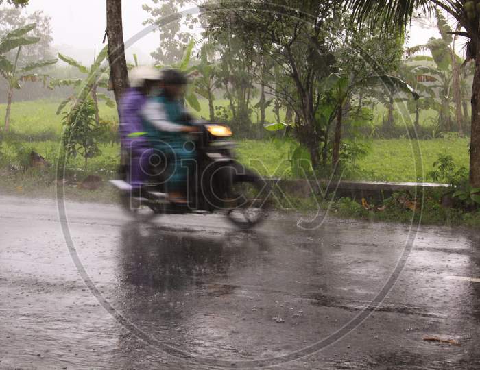 Fast Motorcycle With Riders Blur During Heavy Rain