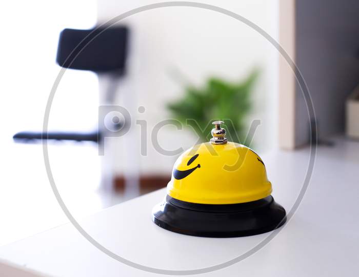 Office Yellow Smiley Bell In A White Table