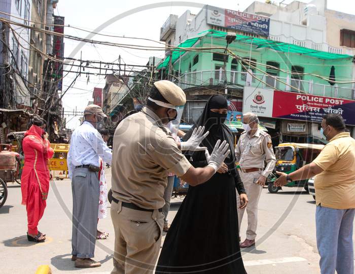 Police check people who Walk Towards Jama Masjid After The Opening Of Most Of The Religious Places As India Eases Lockdown Restrictions That Were Imposed To Slow The Spread Of The Coronavirus Disease (Covid-19), In The Old Quarters Of Delhi, India, June 8, 2020.