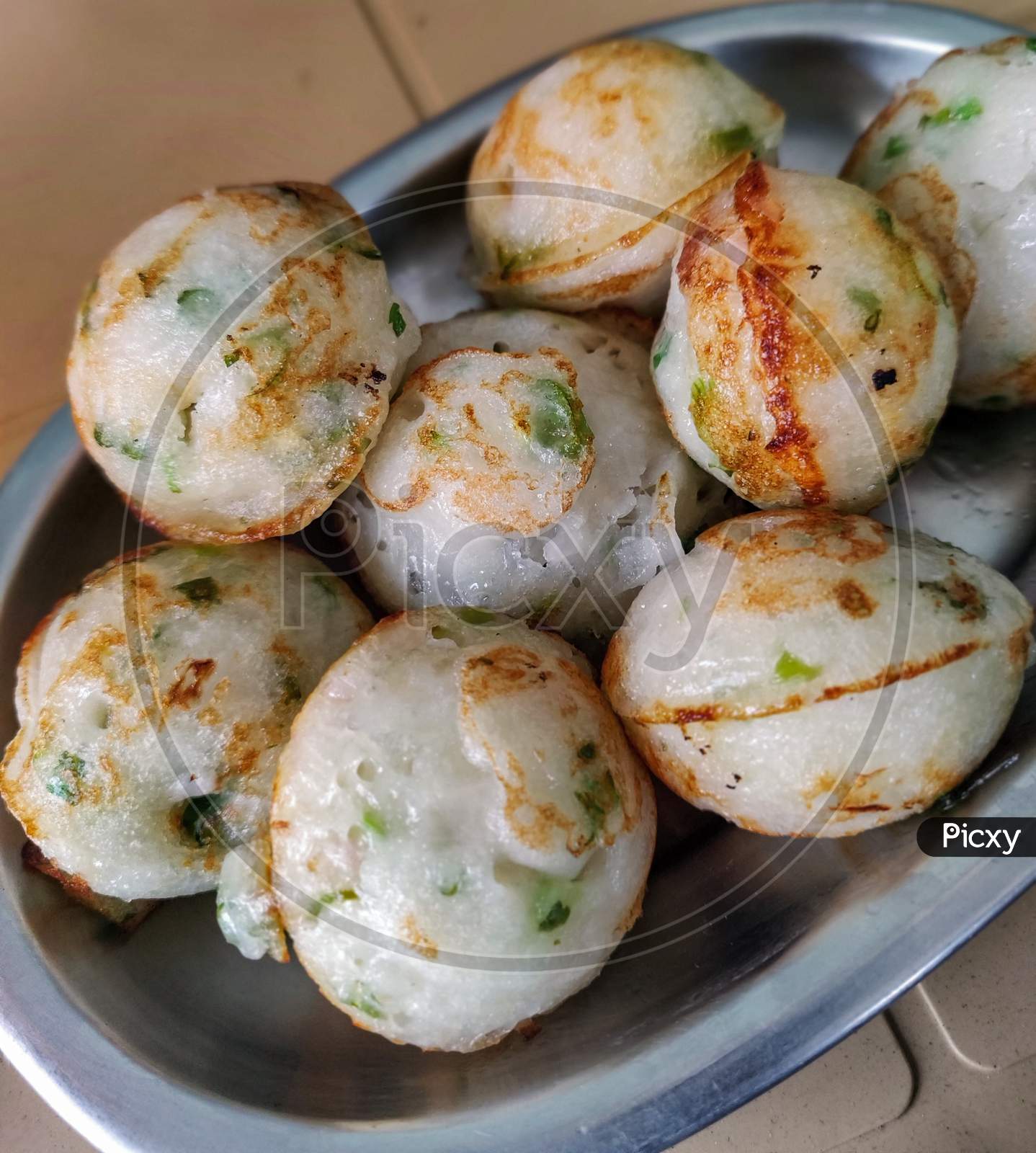 Close Up Of Plate Full Of Paddu. Selective Focus.
