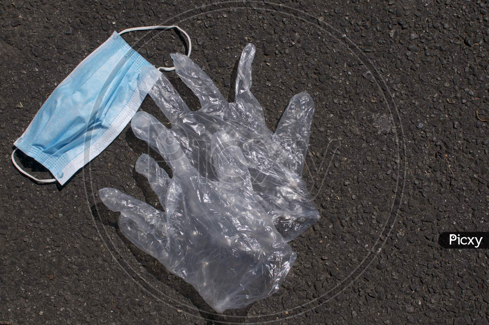 Surgical Mask And Disposable Gloves Dumped On A Street