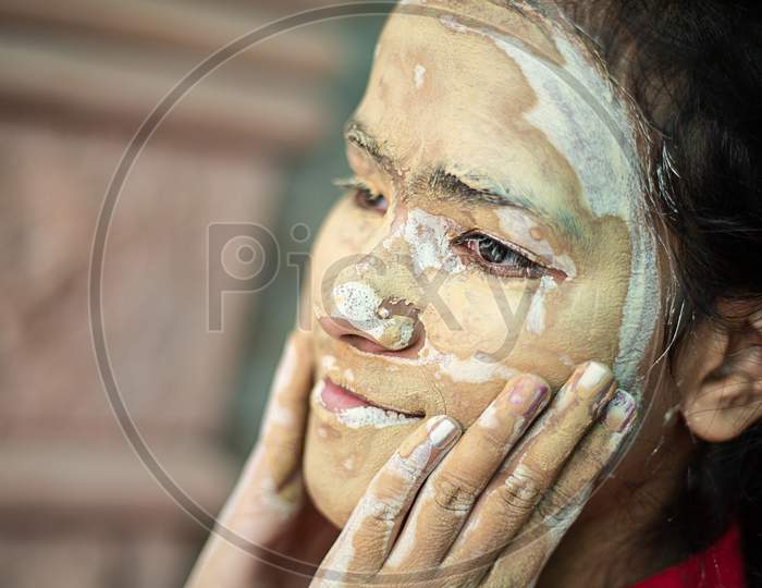 Young Brunette Girl Message Ayurvedic Natural Hearbal Cosmetic Facial Mask Applied Over Her Face. Multani Mitti/Fuller Earth Clay Pack C