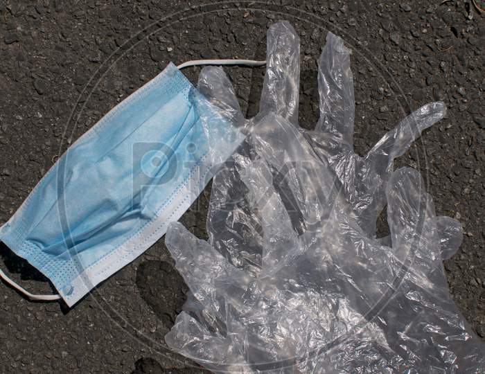 Surgical Mask And Disposable Gloves Dumped On A Street