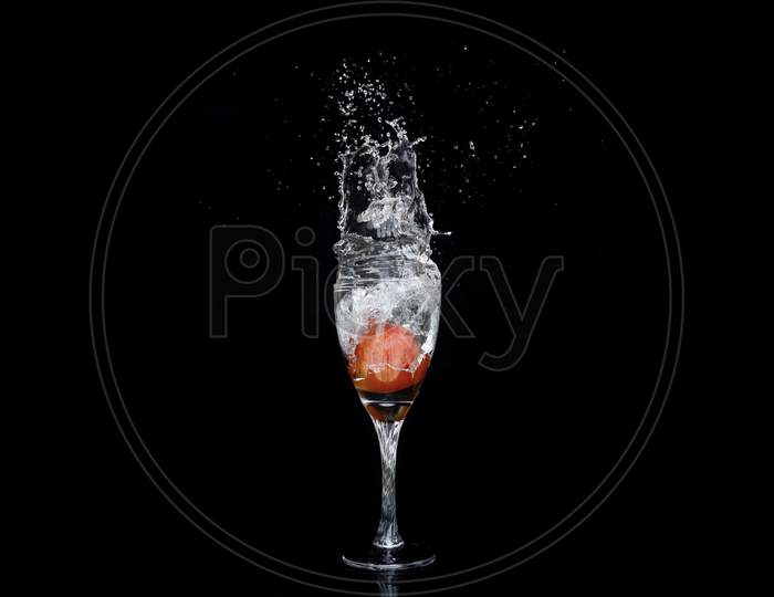 Beautiful Splash Of Water Into Wine Glass