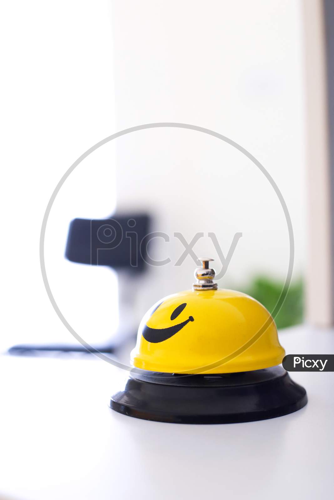 Office Yellow Smiley Bell In A White Table