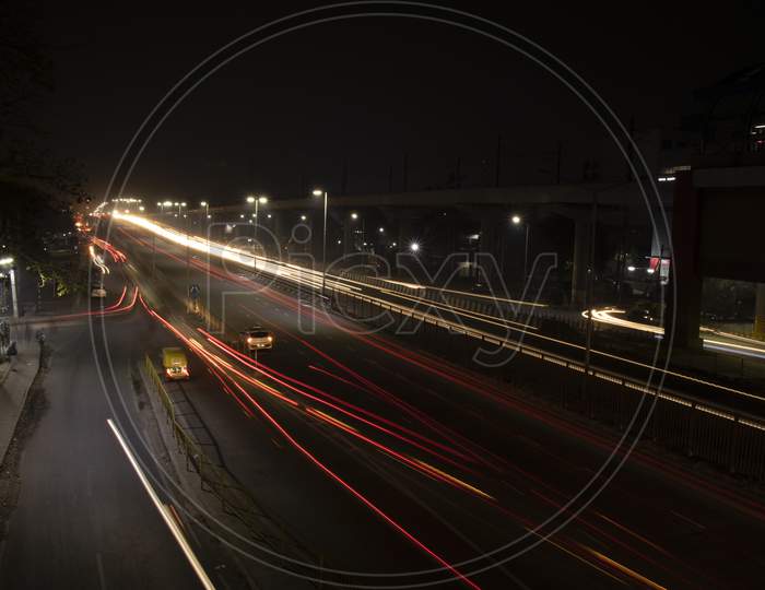 Speed Traffic Light Trails On Highway, Long Exposure, Urban Background And Dark Sky