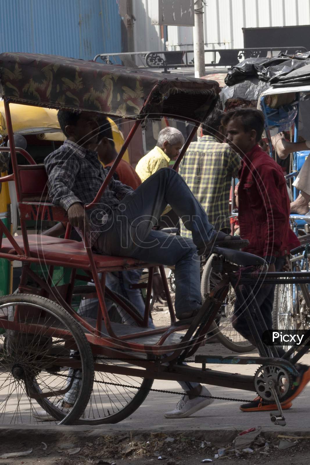 Rickshaw driver having rest on seat