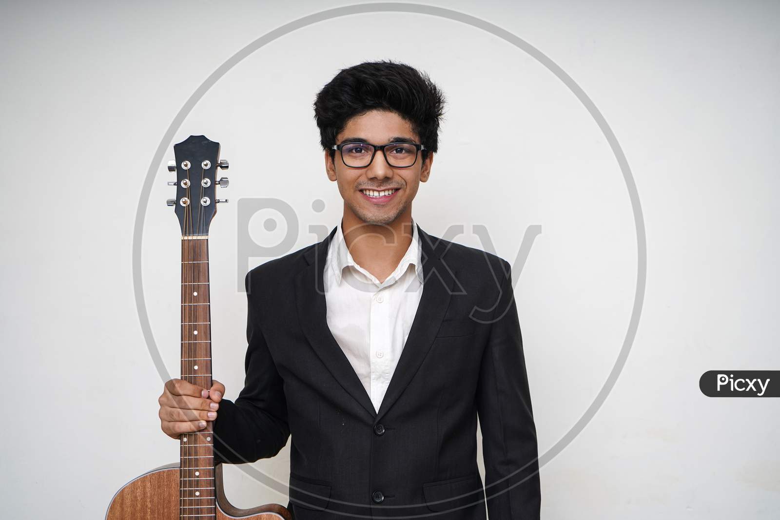 Young Handsome Asian Boy Wearing Formal And Specs Holding A Guitar