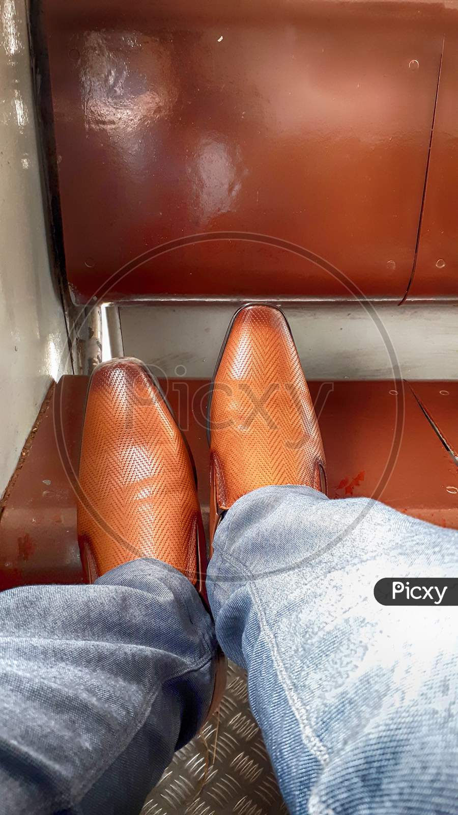This Is A Picture Of A Man Wearing A Pair Of Brown Shoes.