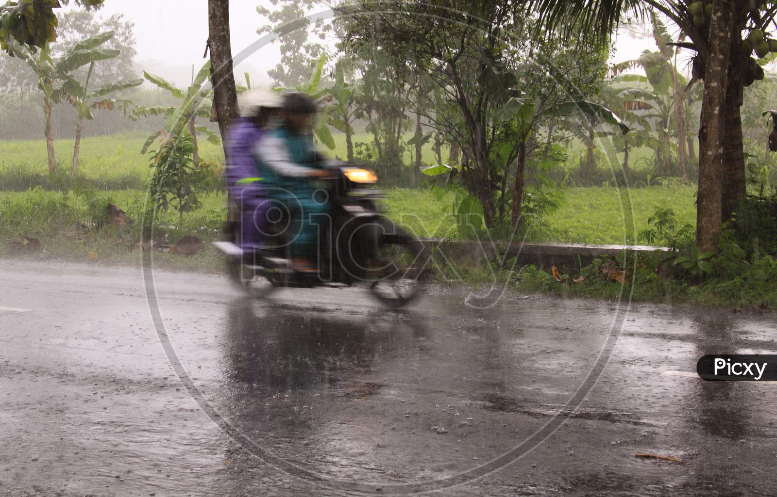 Fast Motorcycle With Riders Blur During Heavy Rain