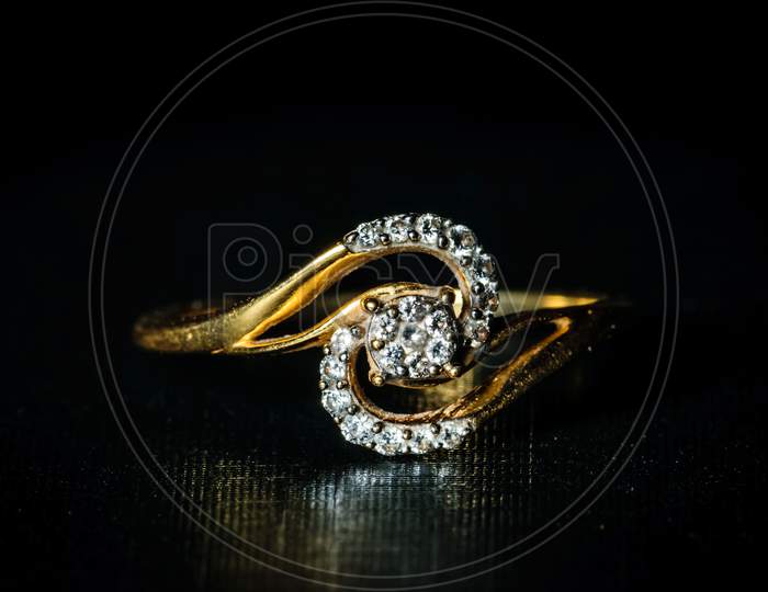 Macro Shot Of A Golden Diamond Ring In A Dark Background