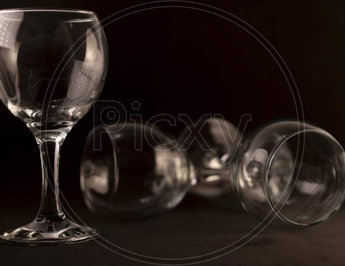 Picture of empty wine glasses against a black background