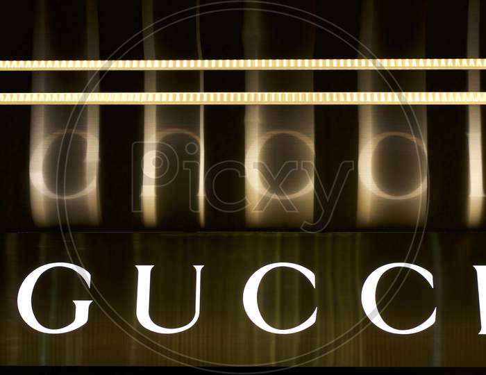 Illuminated And Reflected Gucci Sign