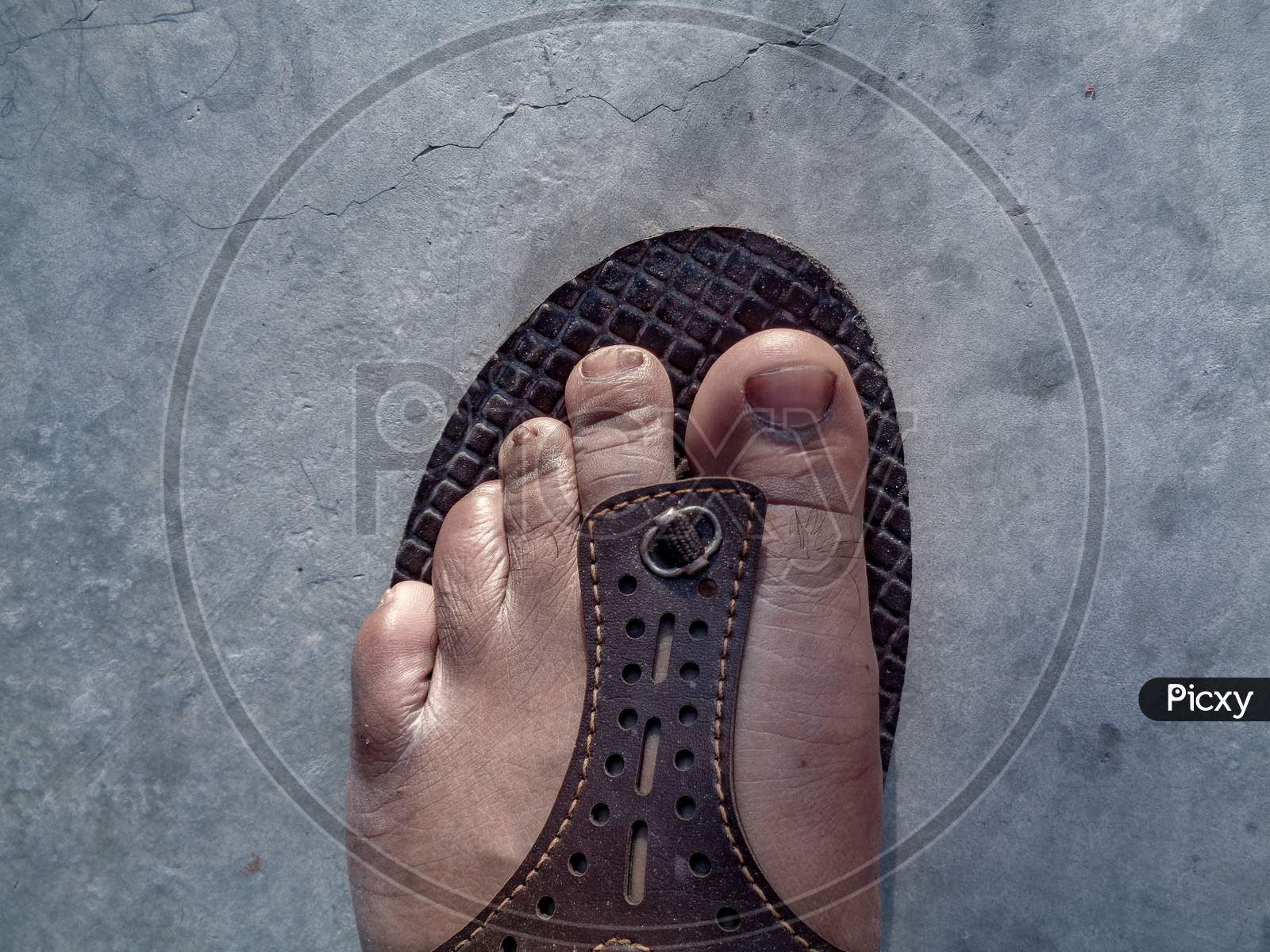 Indian man feet wearing leather chappal