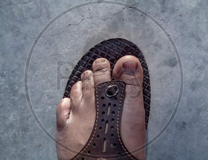 Indian man feet wearing leather chappal