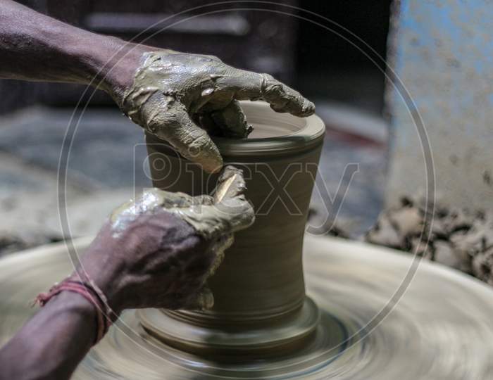 Close Up Of Hands Making A Pot With Mud