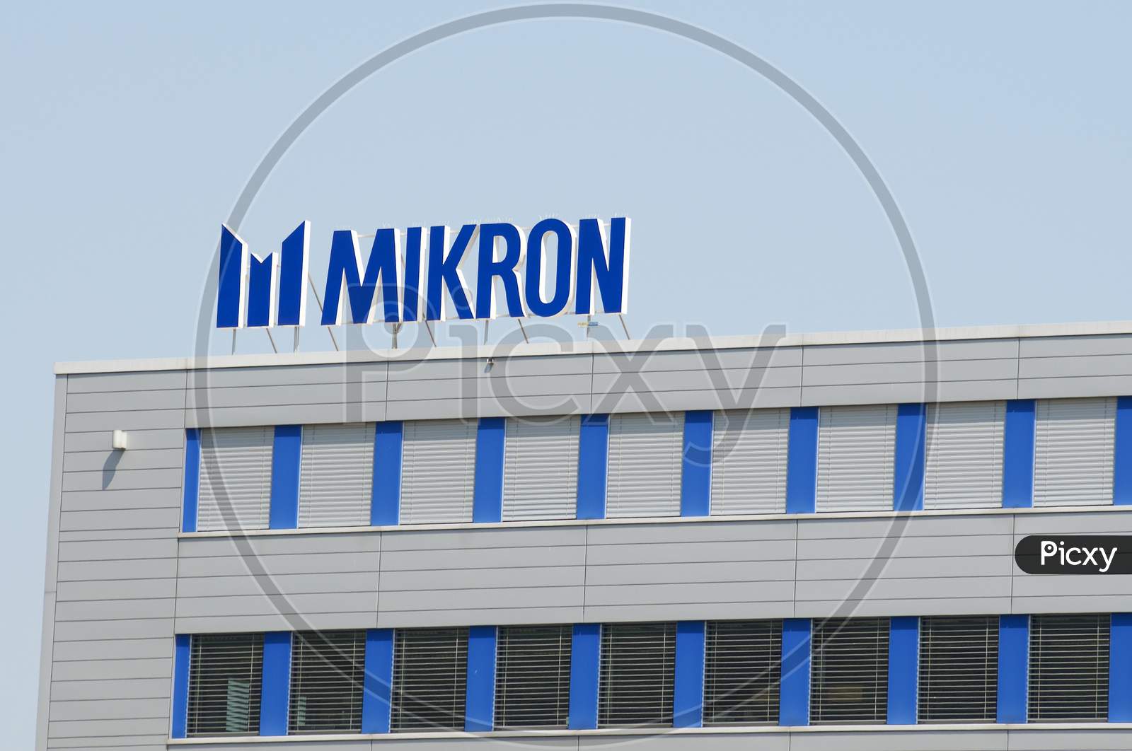 Logo Of Mikron Group In Agno, Switzerland