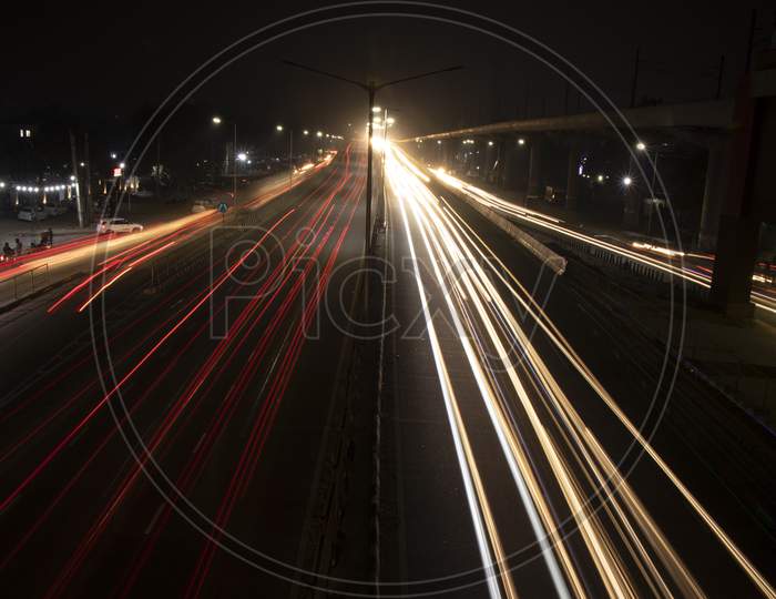 Speed Traffic Light Trails On Highway, Long Exposure, Urban Background And Dark Sky