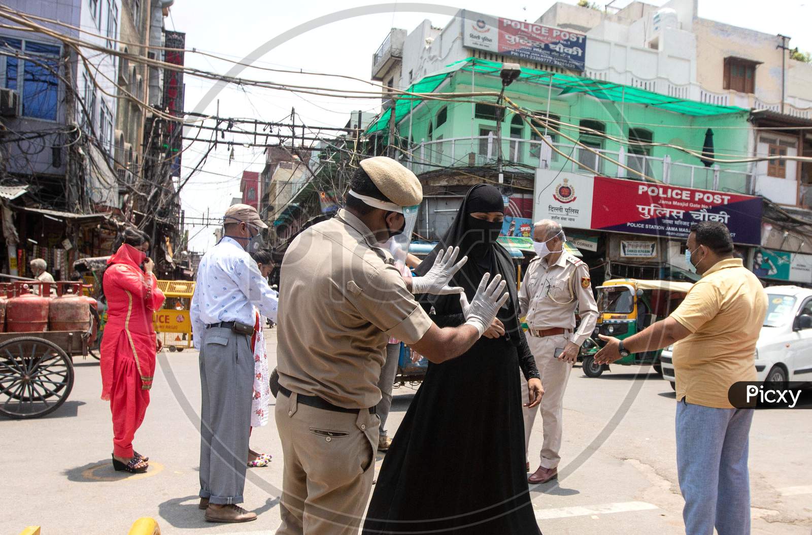 Police check people who Walk Towards Jama Masjid After The Opening Of Most Of The Religious Places As India Eases Lockdown Restrictions That Were Imposed To Slow The Spread Of The Coronavirus Disease (Covid-19), In The Old Quarters Of Delhi, India, June 8, 2020.