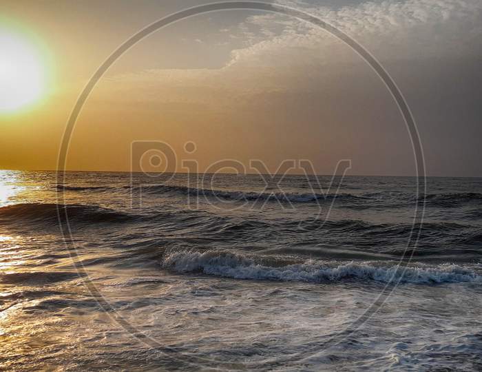 A Picture Of The Sunrise Near The Seashore.