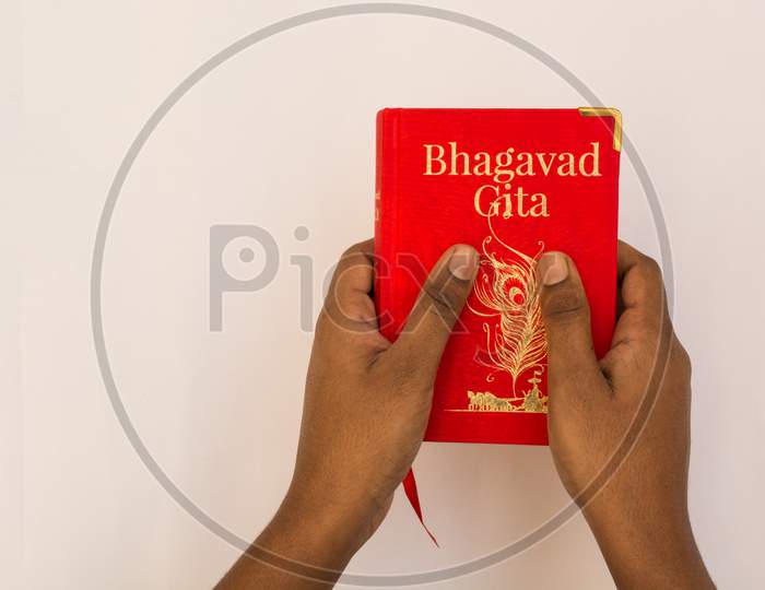 Holding Bhagavad Gita With Hands