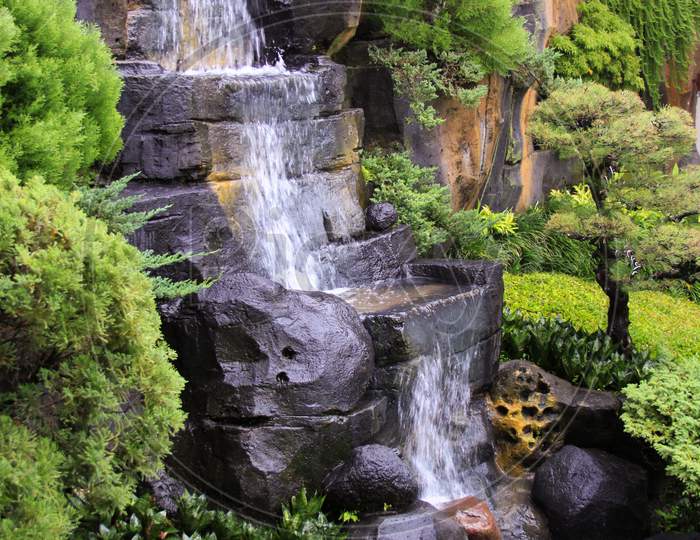 Stone Waterfall In Interior Patio Garden River