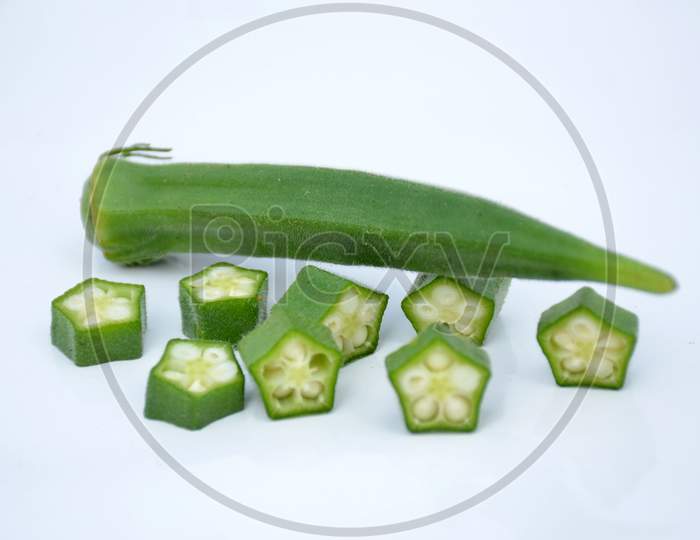 the ripe green ladyfinger with cutt roll isolated on white background.