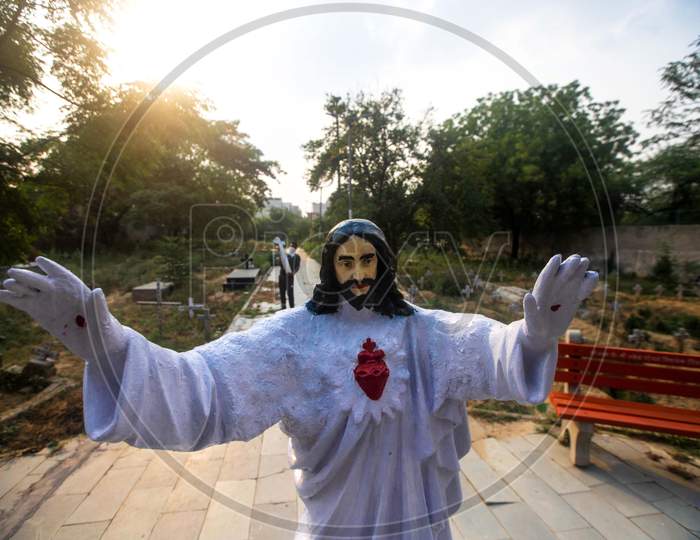 A Cemetery Worker Carries A Cross Past Newly Dug Graves At Mangolpuri Cemetery Amid The Covid-19 Pandemic On July 1, 2020 In New Delhi, India.