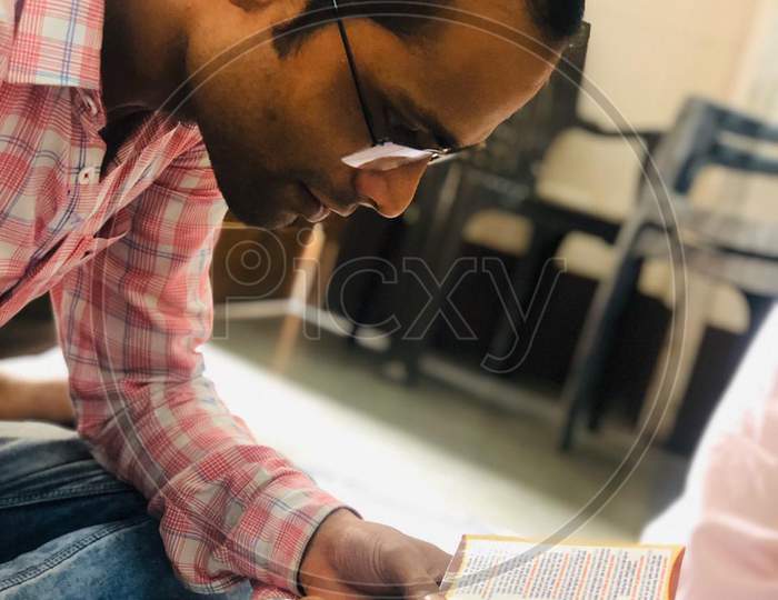 Indian adult man wearing spax in the classroom