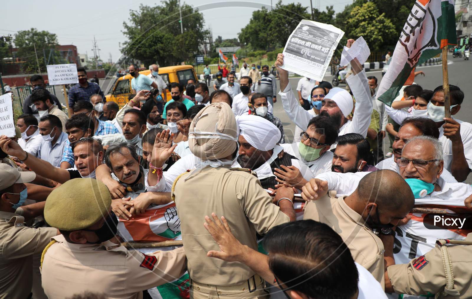 Congress Party workers who were moving towards the Divisional Commissioner Office are stopped by the police as they protest against the hike in the prices of petrol and diesel, in Jammu
